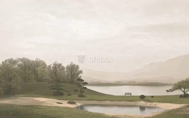 Um lago sereno com montanhas ao fundo, grama verde e um banco solitário em uma paisagem calma.