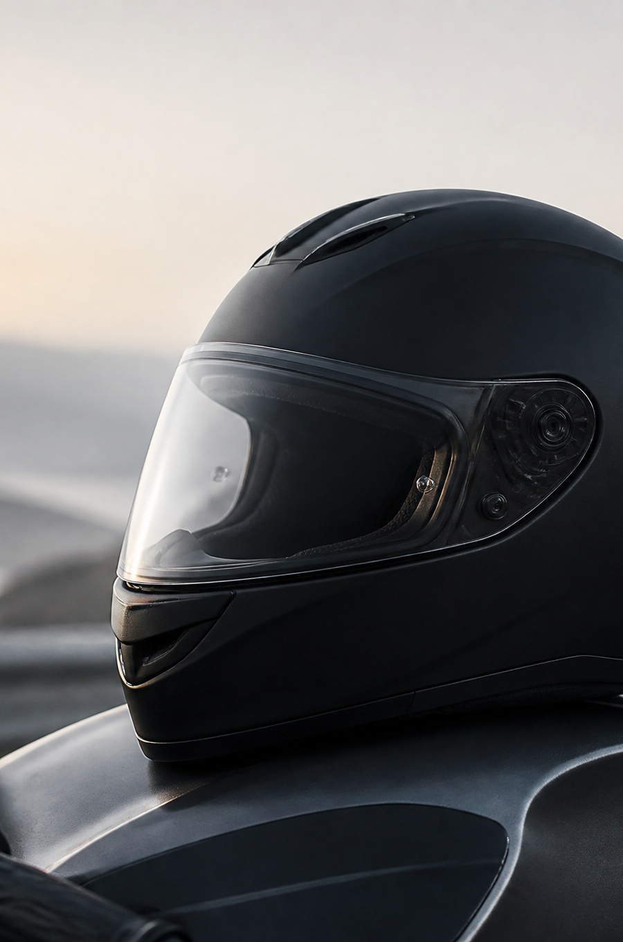 Black full-face helmet resting on a motorcycle