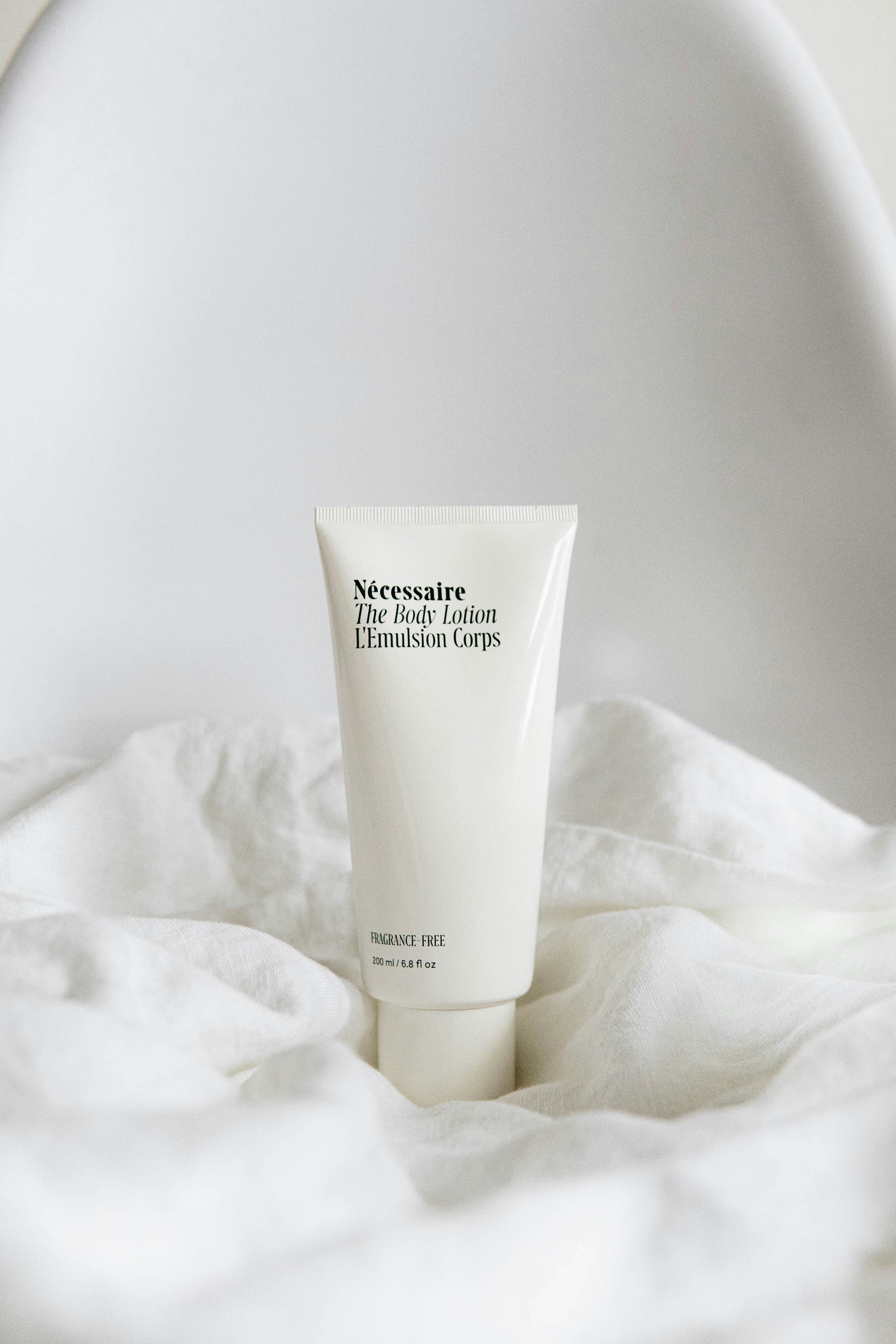 Lumina Repair peptide serum standing on soft white fabric