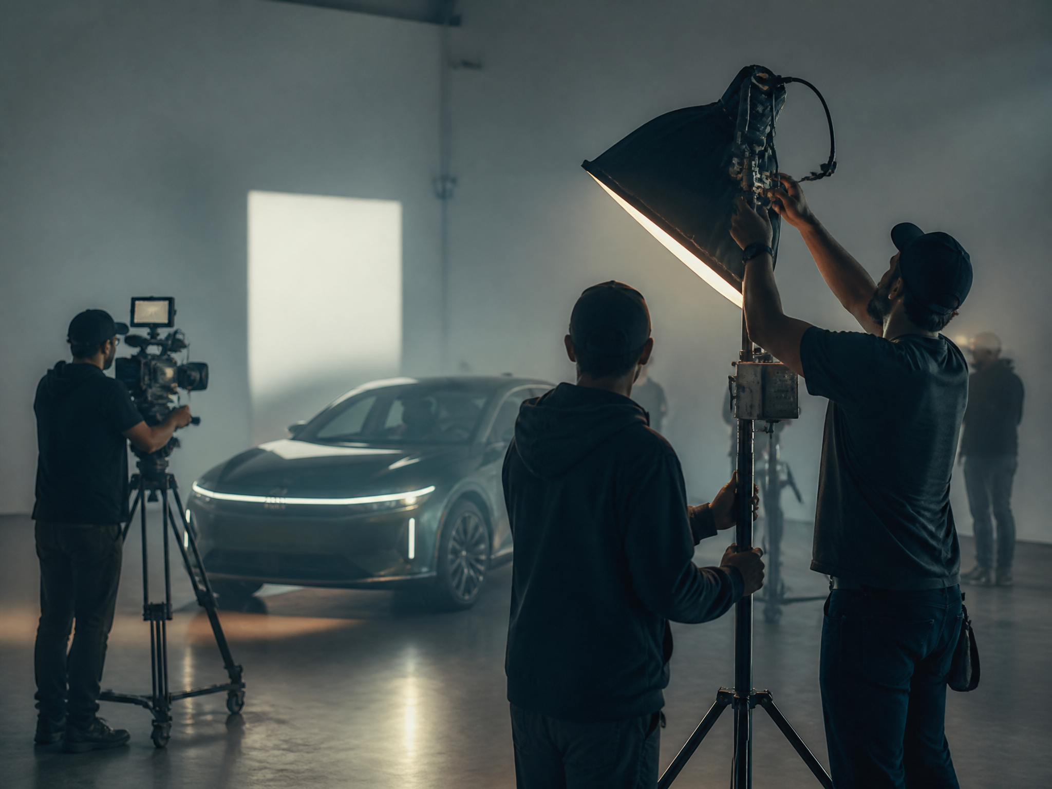 Film production crew adjusting lighting on location