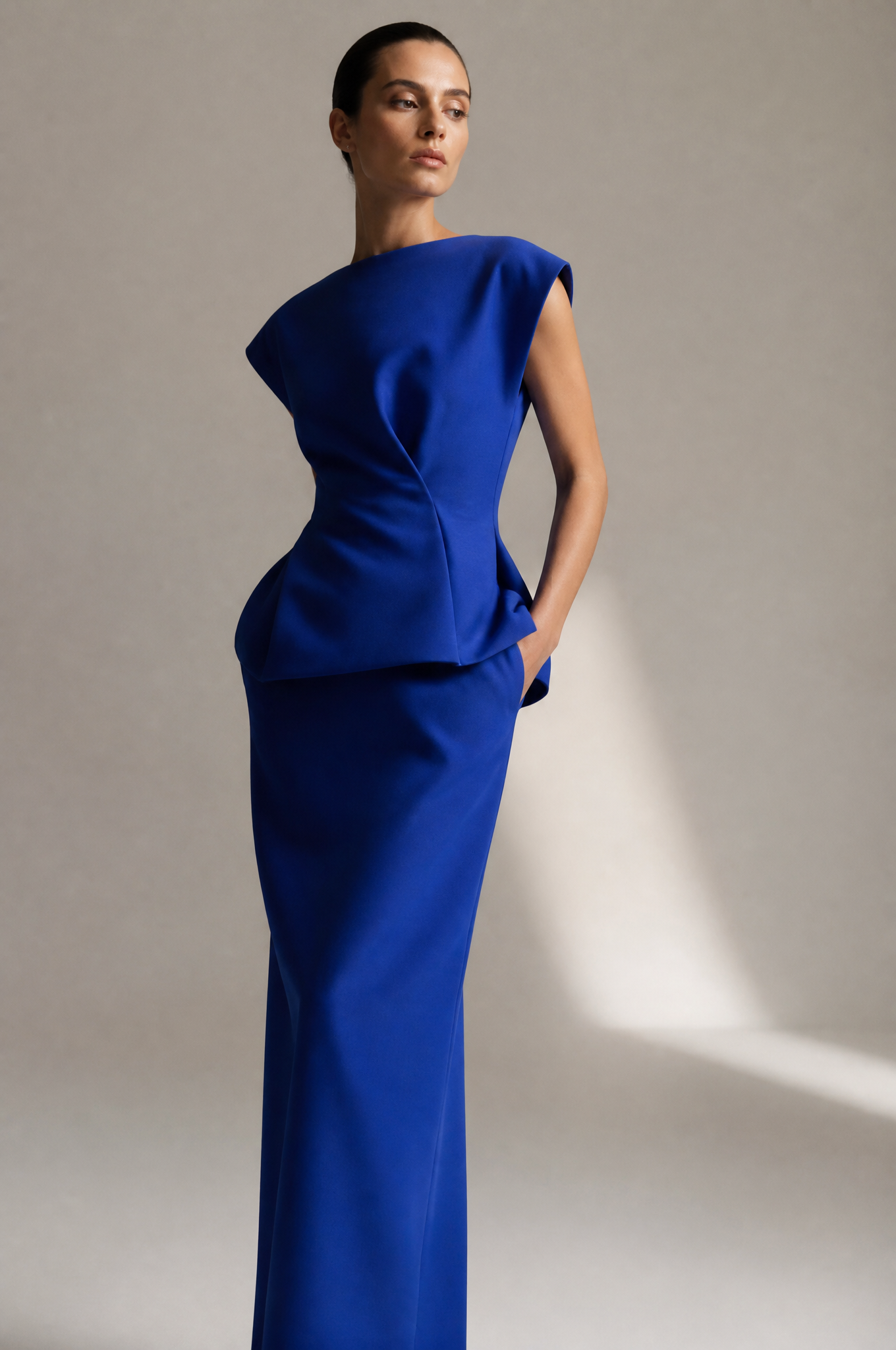Model wearing a structured cobalt fashion silhouette