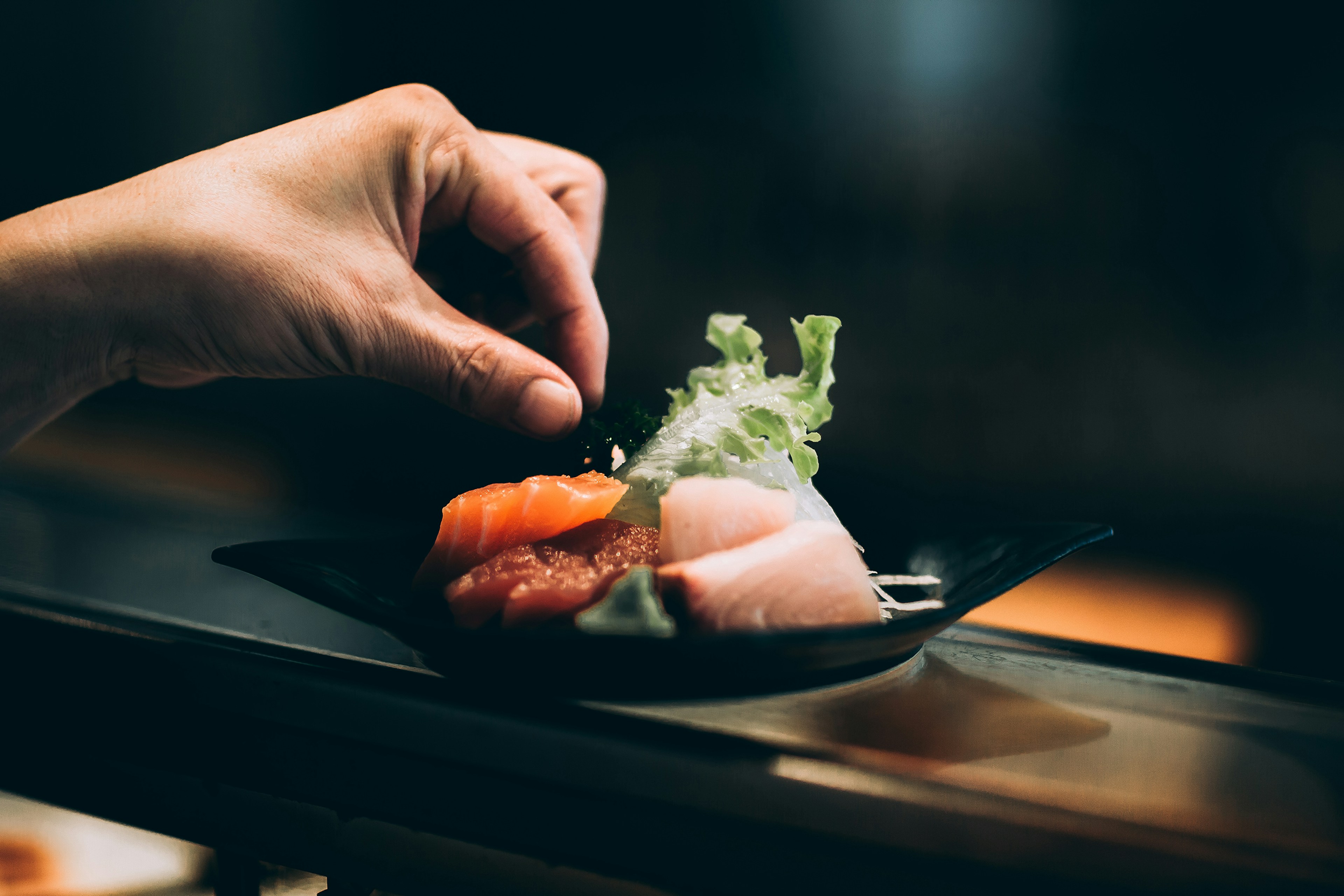 Plated sushi roll with greens